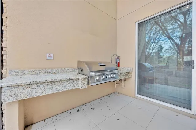 a living room with a stove and a refrigerator