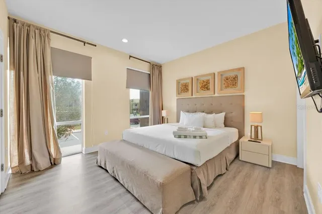 a spacious bedroom with a bed and a large window