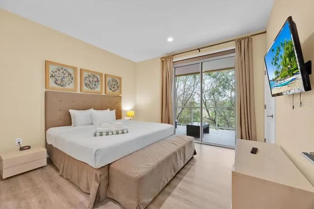 a bedroom with a bed and a large window