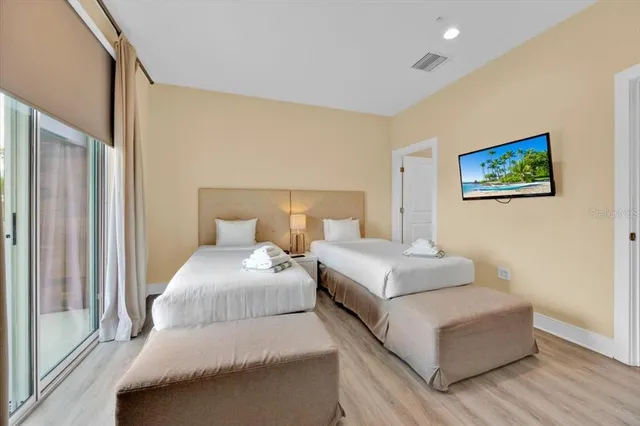 a bedroom with a bed and a large window