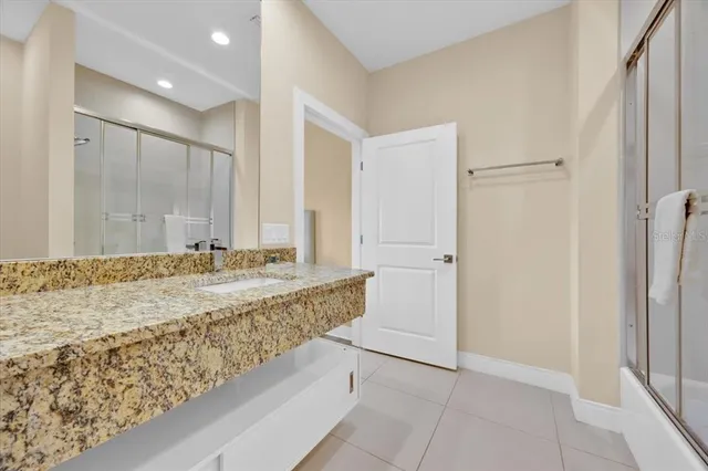 a bathroom with a tub shower and sink