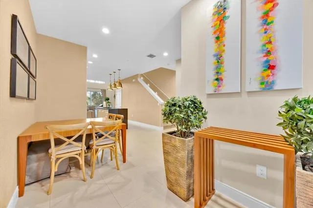 a dining room table with potted plants and painted walls