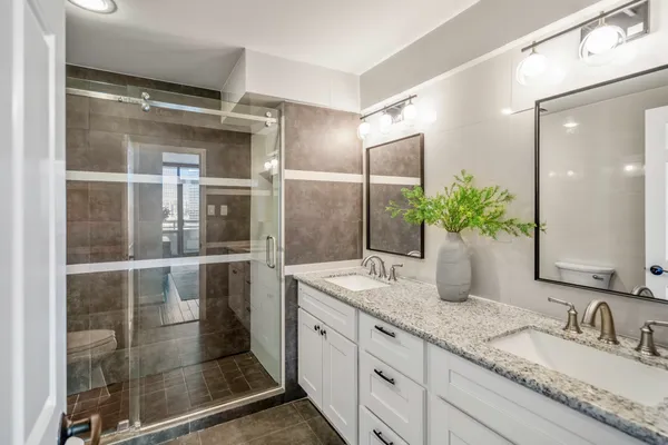 a bathroom with a granite countertop sink and a mirror