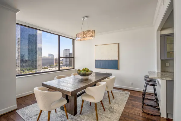 a view of a dining room with furniture window and wooden floor