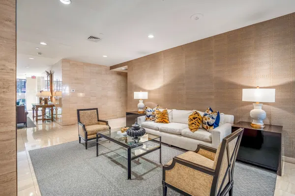 a living room with furniture and a lamp