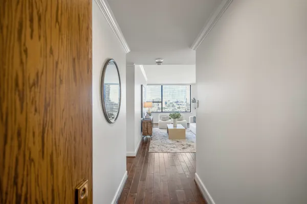 a room with wooden floor and windows