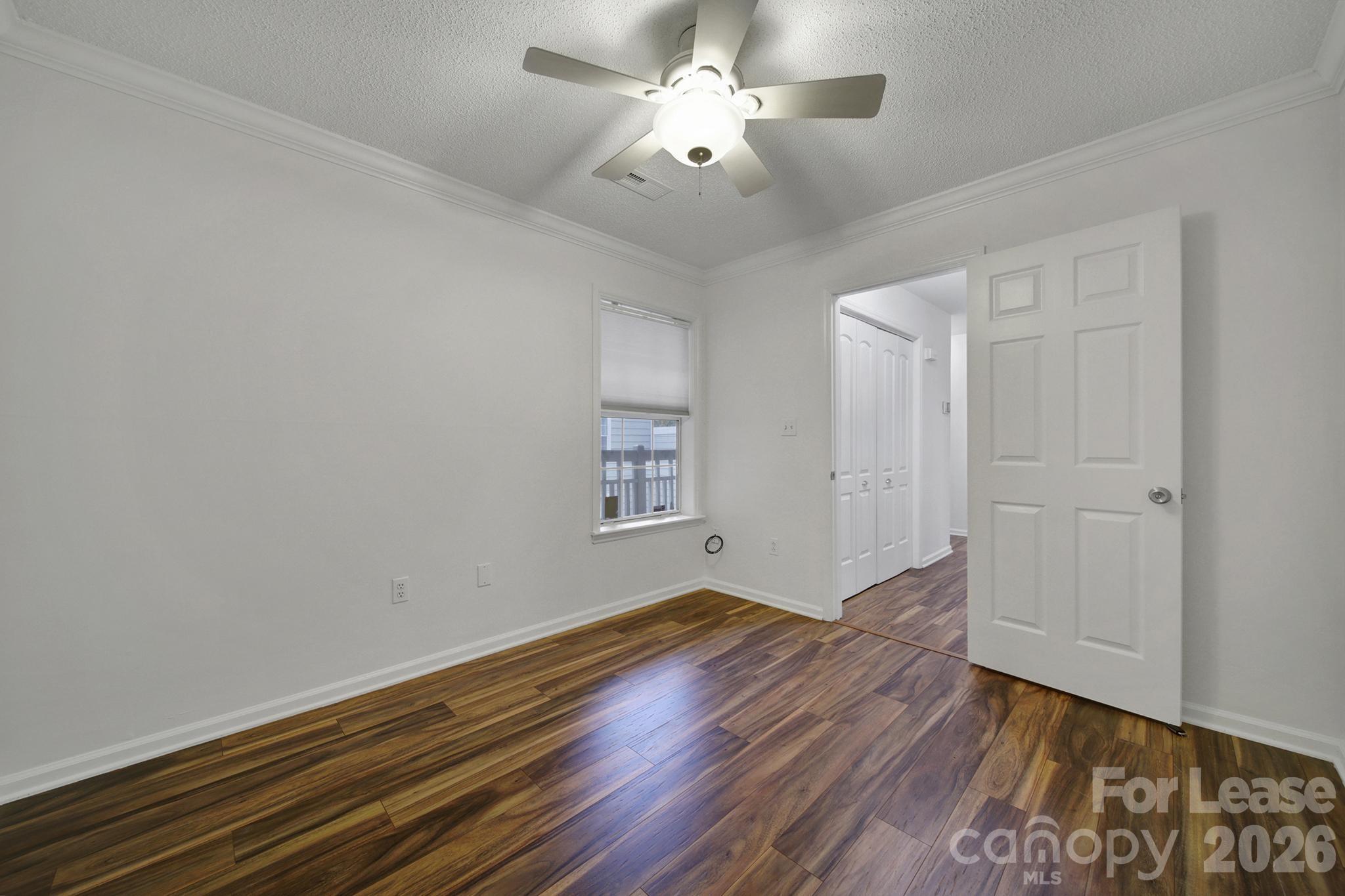5007 Sharon Road, Unit E Charlotte, NC 28210 - Photo 14 of 24 a view of empty room with wooden floor