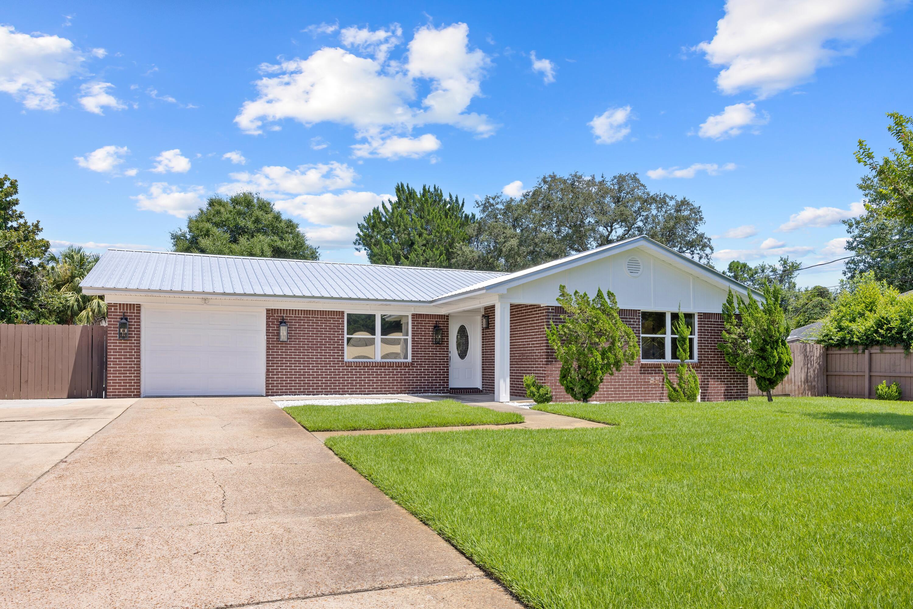 a front view of house with yard and green space