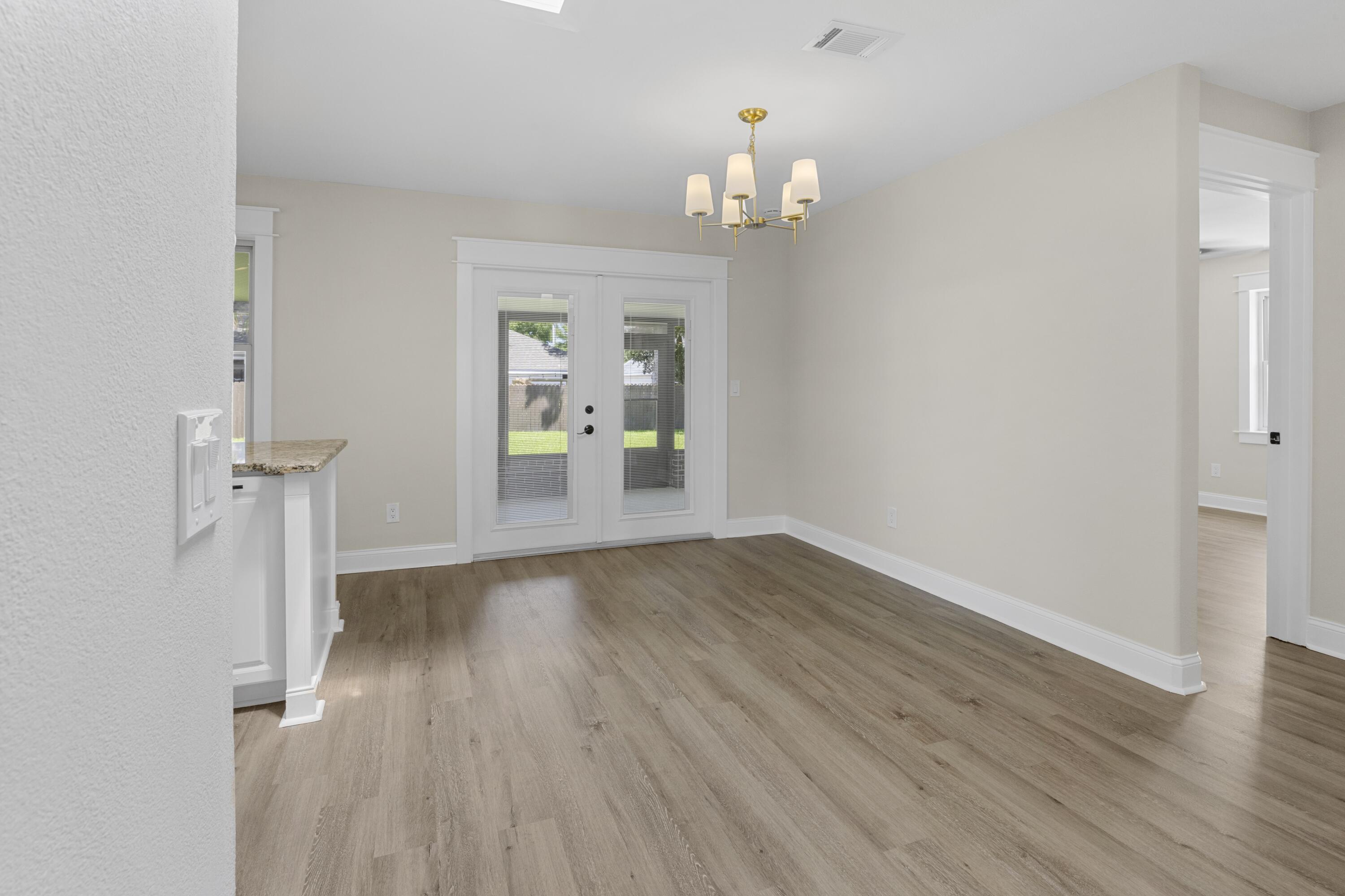 308 Spring Lane Destin, FL 32541 - Photo 13 of 47 wooden floor in an empty room with a window