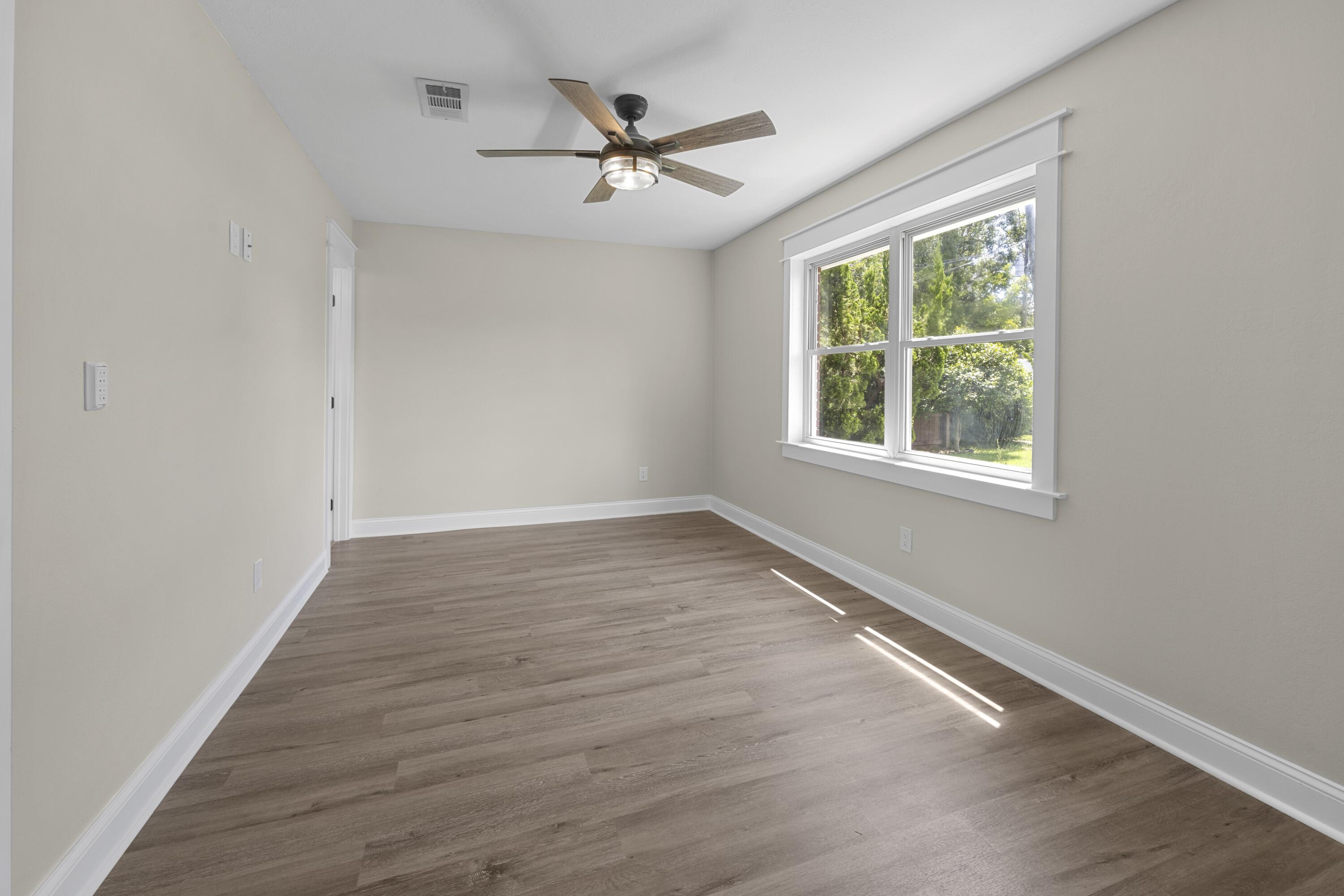 308 Spring Lane Destin, FL 32541 - Photo 16 of 47 wooden floor in an empty room with a window