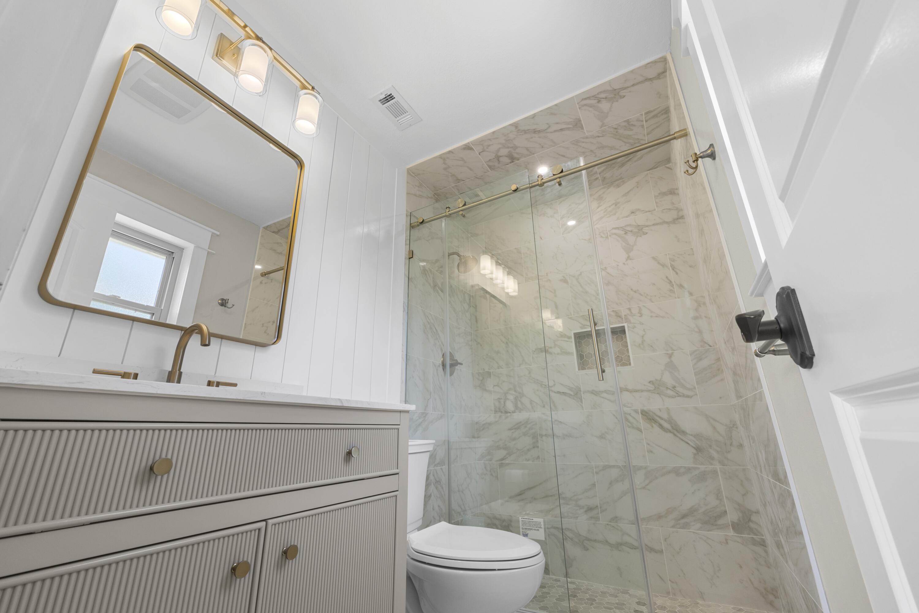 308 Spring Lane Destin, FL 32541 - Photo 21 of 47 a bathroom with a sink a toilet and a mirror