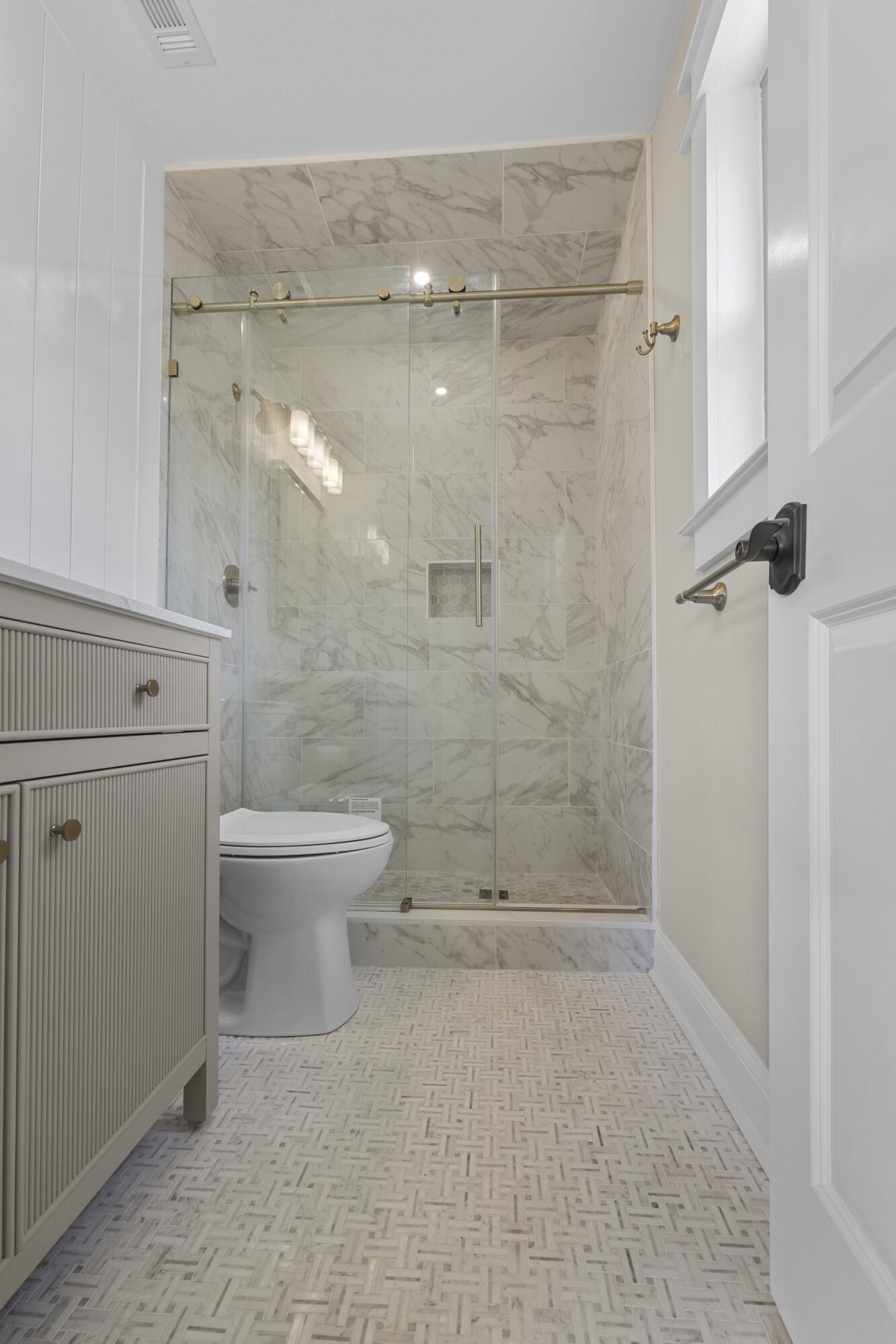 308 Spring Lane Destin, FL 32541 - Photo 22 of 47 a bathroom with a shower a toilet and a sink