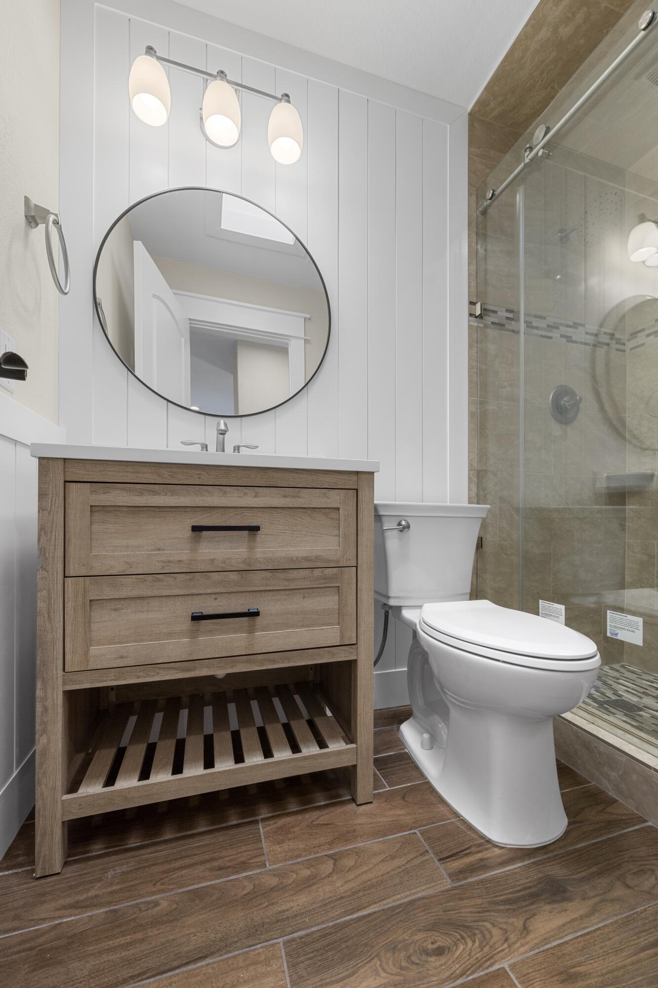 308 Spring Lane Destin, FL 32541 - Photo 23 of 47 a bathroom with a toilet a sink and a mirror