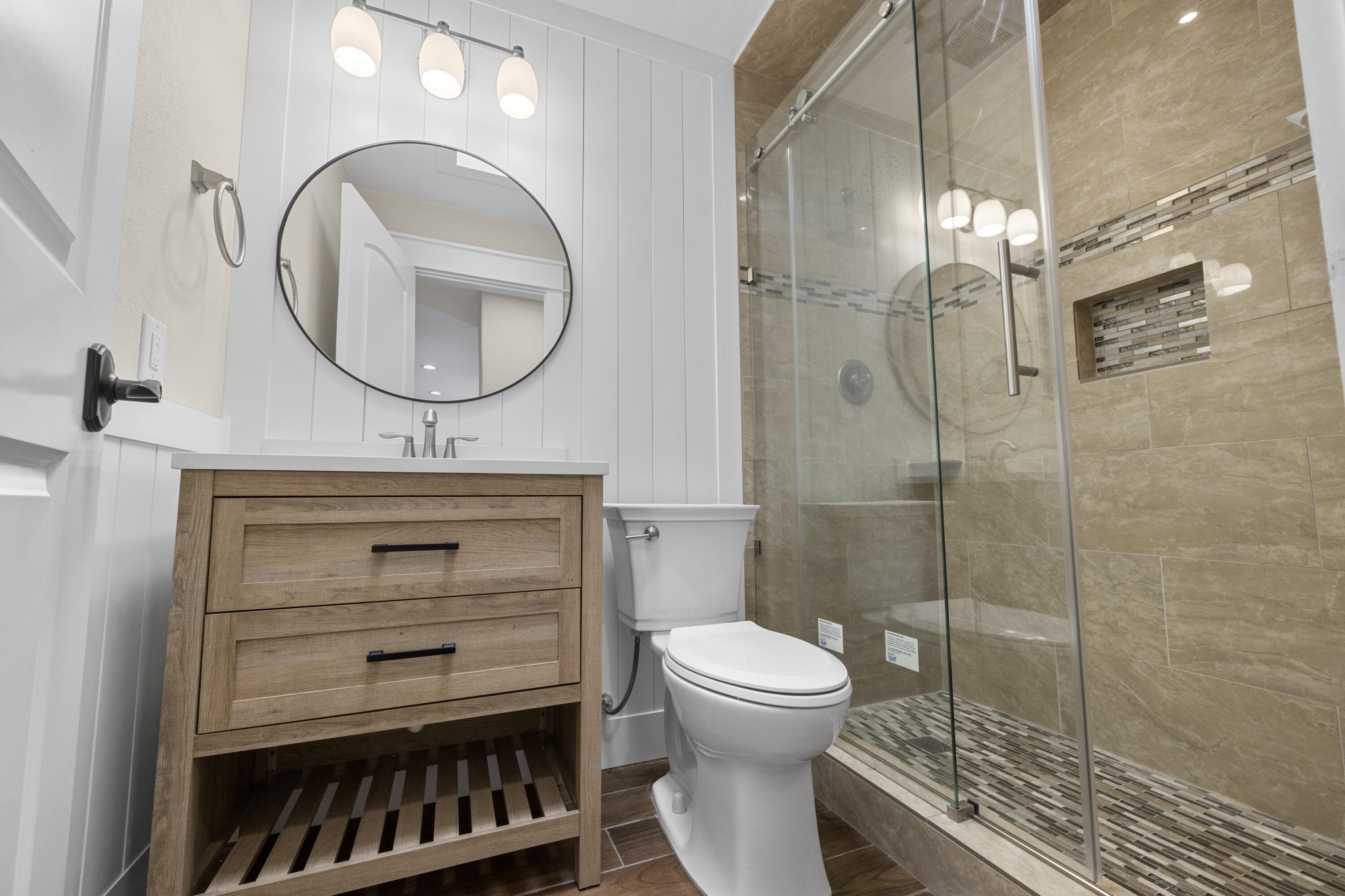 308 Spring Lane Destin, FL 32541 - Photo 24 of 47 a bathroom with a sink a toilet and a mirror