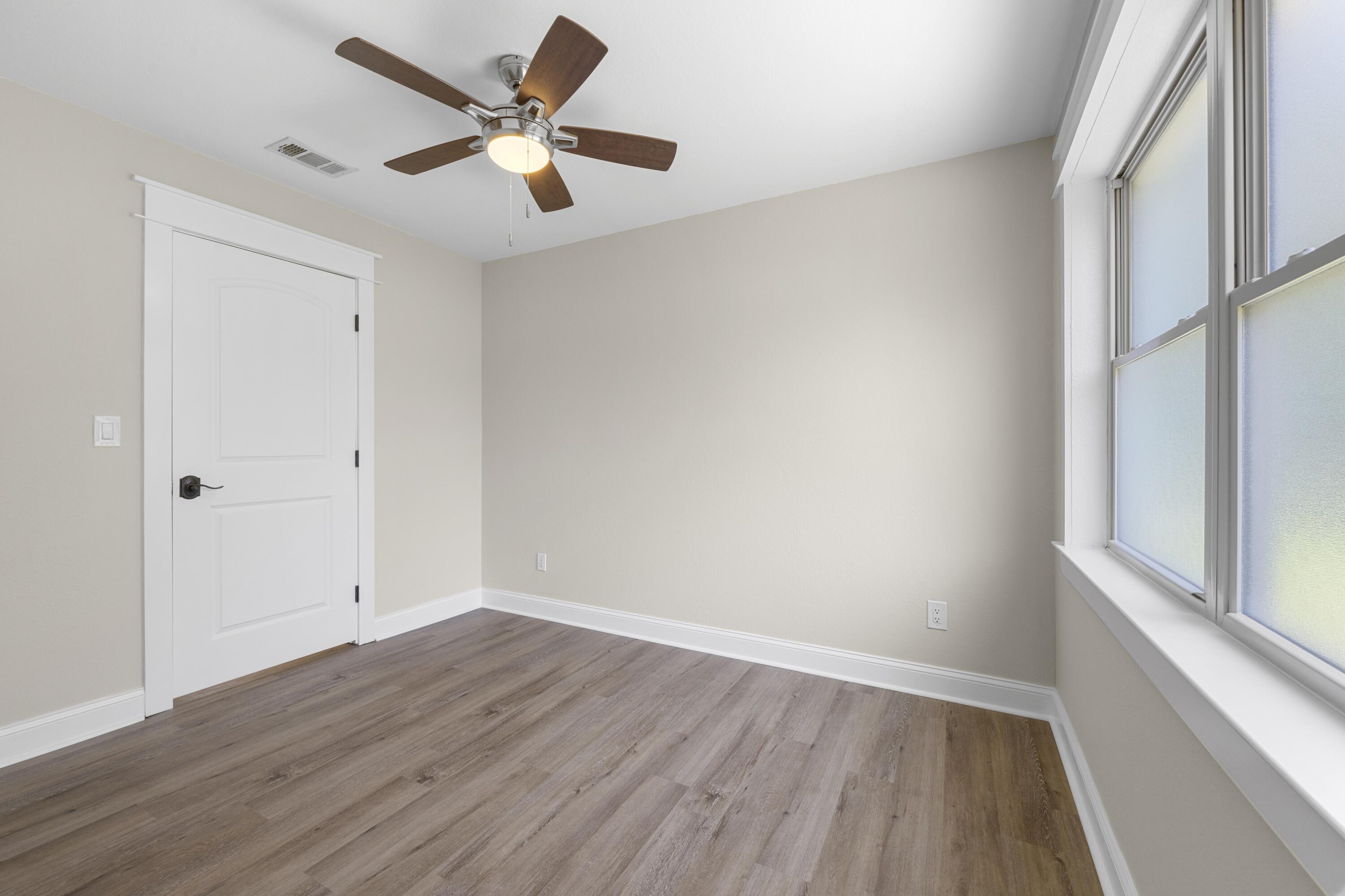 308 Spring Lane Destin, FL 32541 - Photo 27 of 47 wooden floor in an empty room with a window