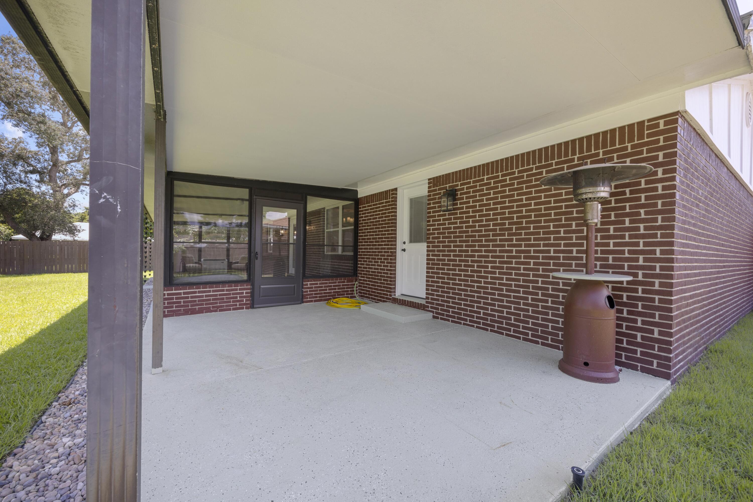 308 Spring Lane Destin, FL 32541 - Photo 34 of 47 a view of an empty room with a floor to ceiling window and potted plants