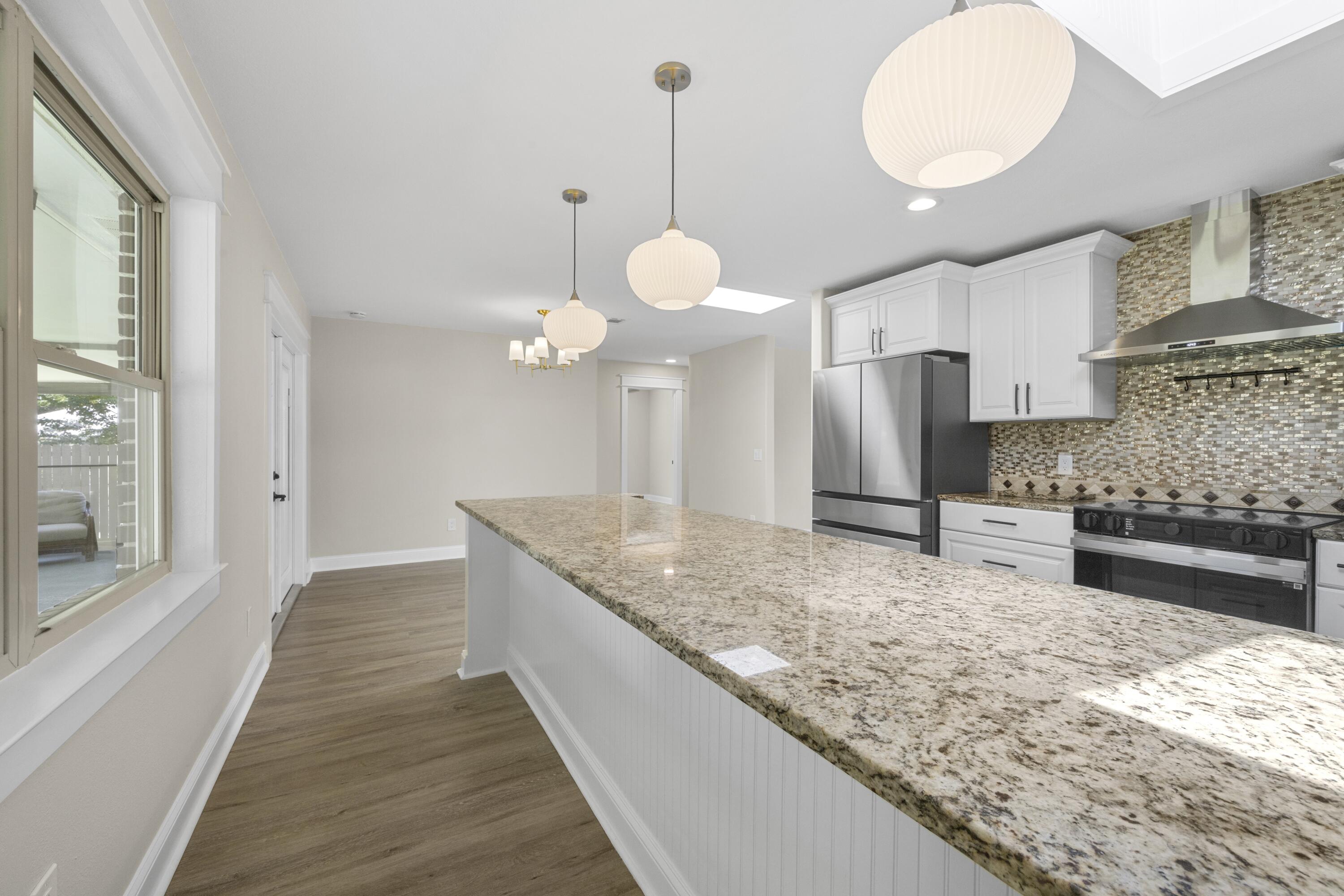 308 Spring Lane Destin, FL 32541 - Photo 5 of 47 a kitchen with stainless steel appliances granite countertop a sink a oven and a granite counter tops