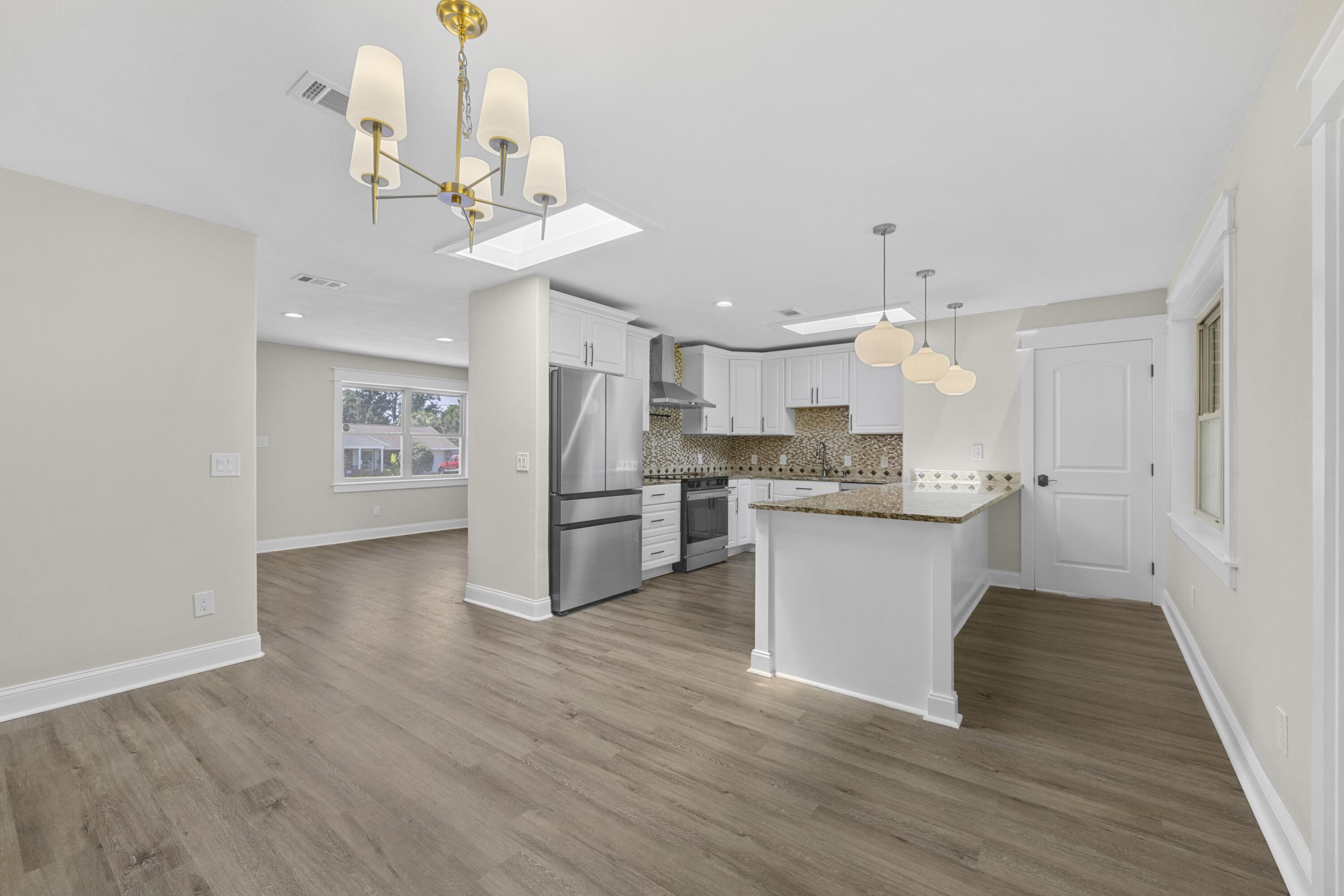 308 Spring Lane Destin, FL 32541 - Photo 6 of 47 a kitchen with a refrigerator cabinets and wooden floor