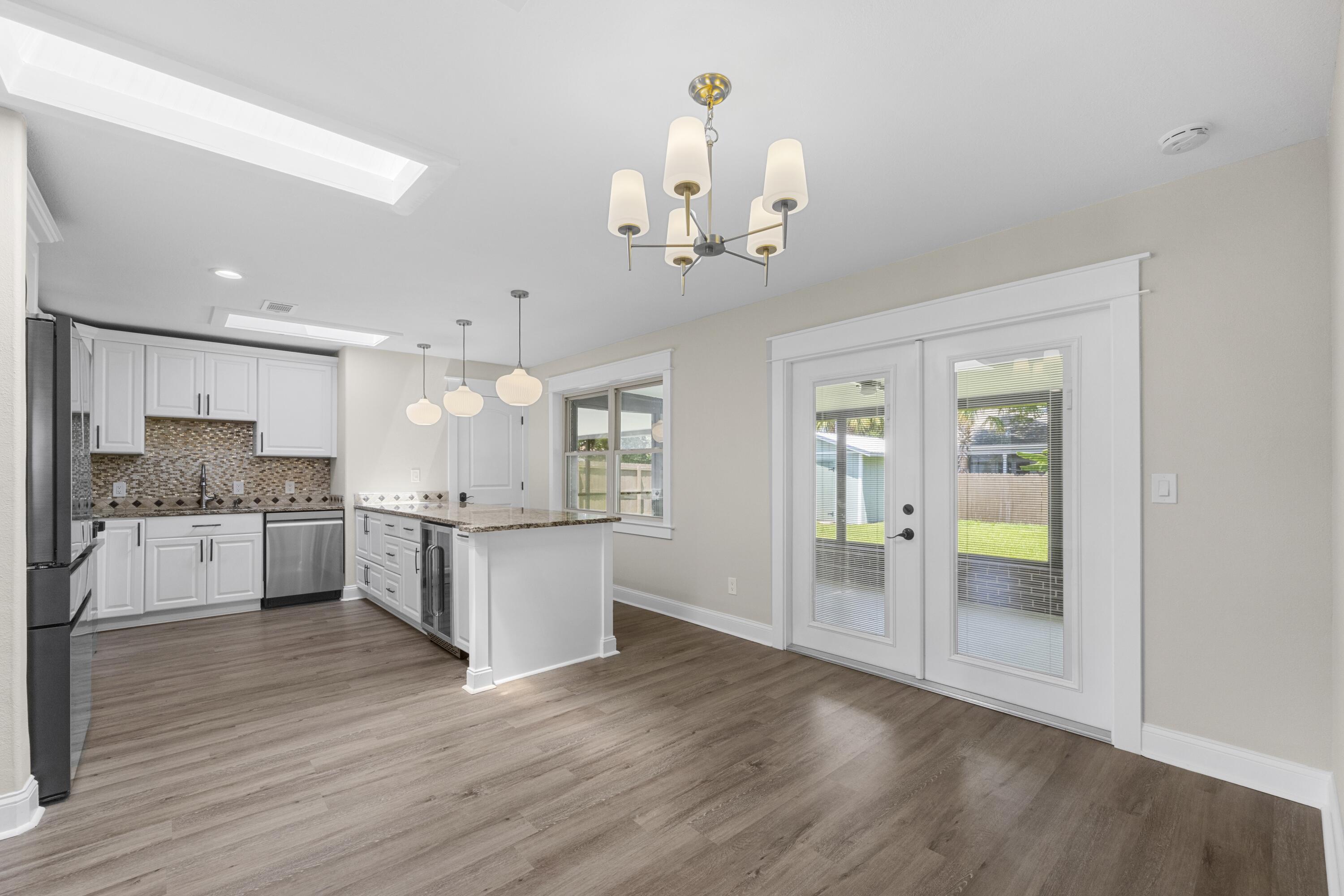 308 Spring Lane Destin, FL 32541 - Photo 7 of 47 a large white kitchen with a refrigerator and a stove top oven