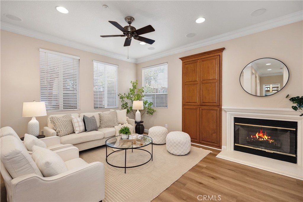 a living room with furniture a fireplace and a large window