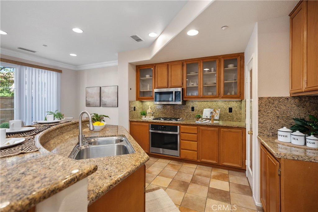 9 Lilac Irvine, CA 92618 - Photo 6 of 49 a kitchen with stainless steel appliances granite countertop sink stove refrigerator and cabinets