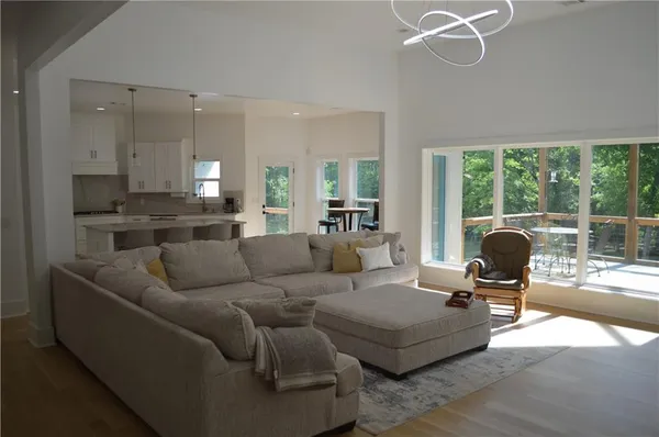 a kitchen with stainless steel appliances a stove a sink a refrigerator a center island and a counter space