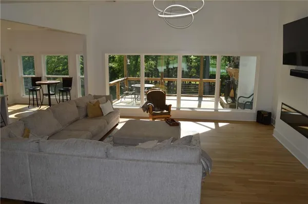 a kitchen with stainless steel appliances granite countertop a refrigerator a sink dishwasher a stove and white countertops with wooden floor