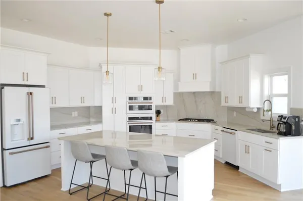 a view of a room with furniture and wooden floor