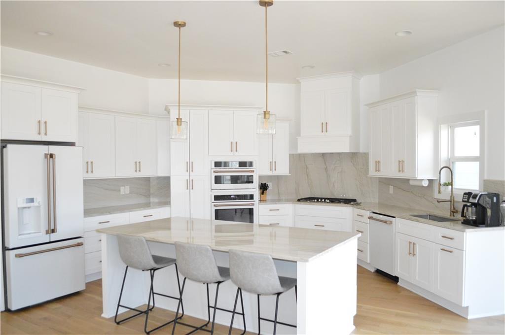 8 Ripplewood Trail Euharlee, GA 30145 - Photo 19 of 90 a kitchen with stainless steel appliances a stove a sink a refrigerator a center island and a counter space