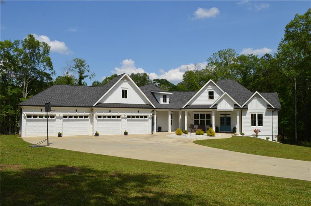 8 Ripplewood Trail Euharlee, GA 30145 - Photo 2 of 90 a front view of a house with a garden and trees