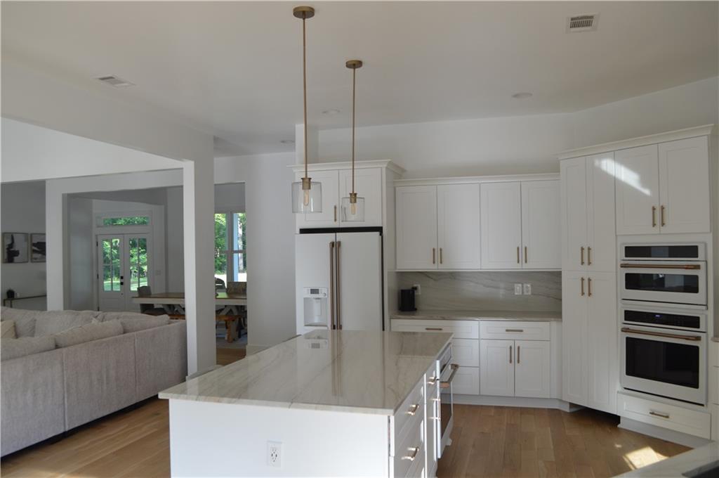 8 Ripplewood Trail Euharlee, GA 30145 - Photo 24 of 90 a kitchen with stainless steel appliances granite countertop a refrigerator a sink and a stove