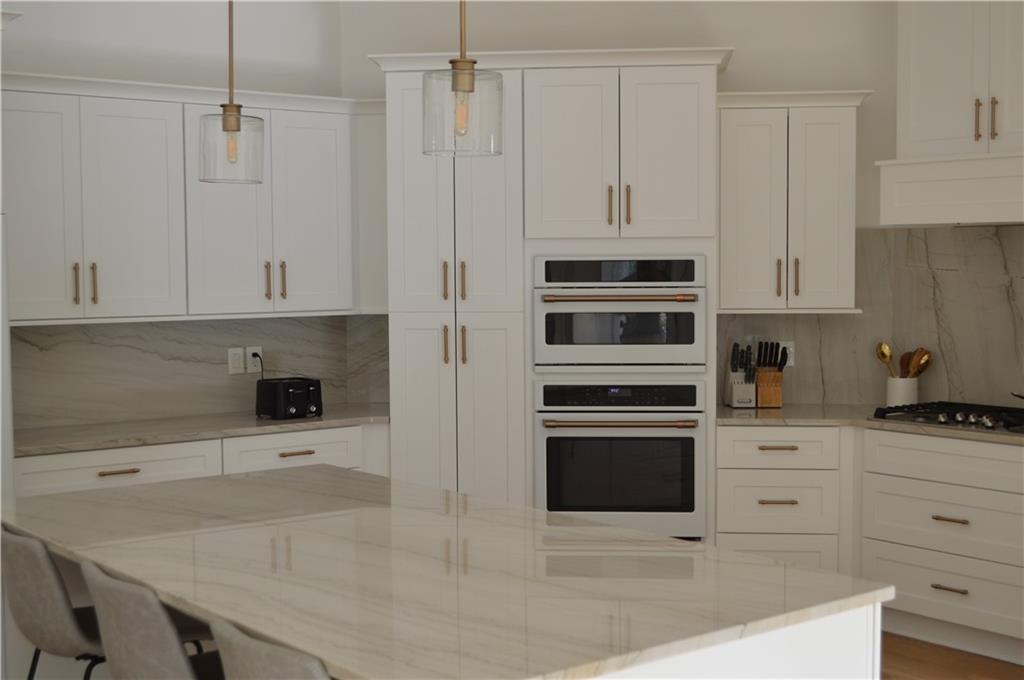 8 Ripplewood Trail Euharlee, GA 30145 - Photo 27 of 90 a kitchen with granite countertop white cabinets and stainless steel appliances