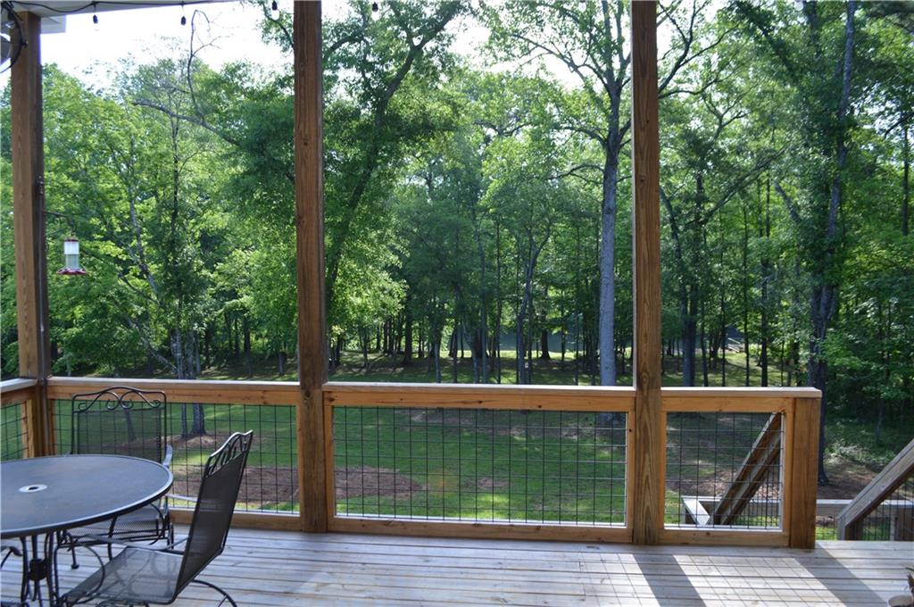 8 Ripplewood Trail Euharlee, GA 30145 - Photo 30 of 90 a view of a chair and table on the wooden deck