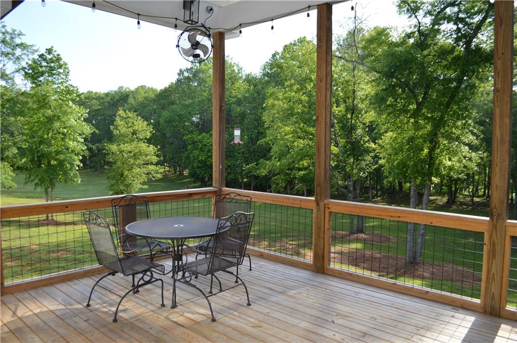 8 Ripplewood Trail Euharlee, GA 30145 - Photo 31 of 90 a view of a deck with table and chairs with wooden floor and fence