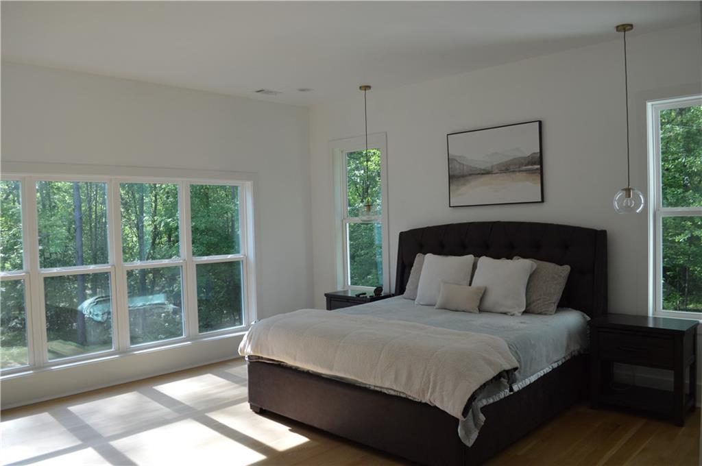 8 Ripplewood Trail Euharlee, GA 30145 - Photo 41 of 90 a large bed sitting in a bedroom next to a window