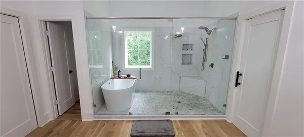 a kitchen with stainless steel appliances kitchen island granite countertop a refrigerator a stove a sink a dining table and chairs