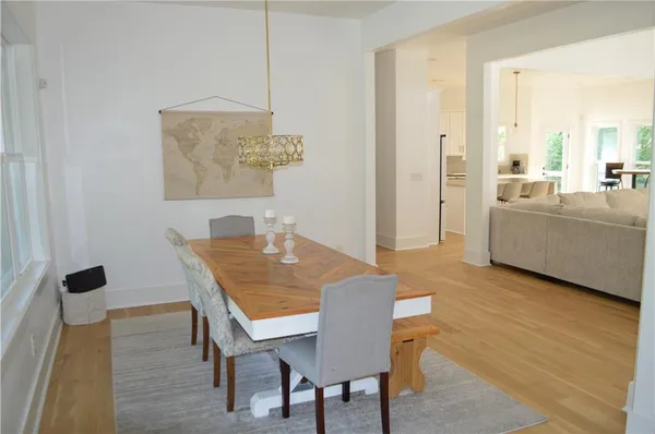 a kitchen with stainless steel appliances granite countertop a sink a stove and a wooden floor