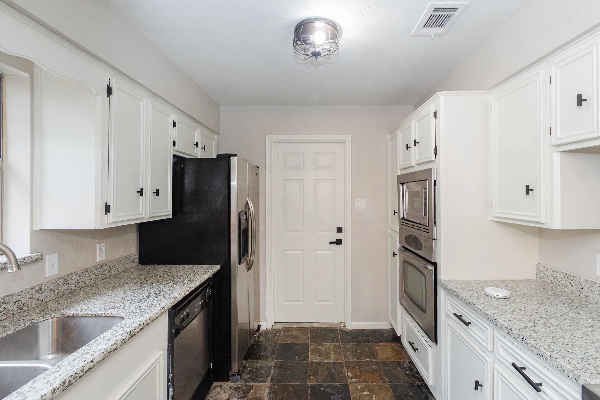 29019 Stapleford Street Spring, TX 77386 - Photo 11 of 29 a kitchen with a sink and a refrigerator