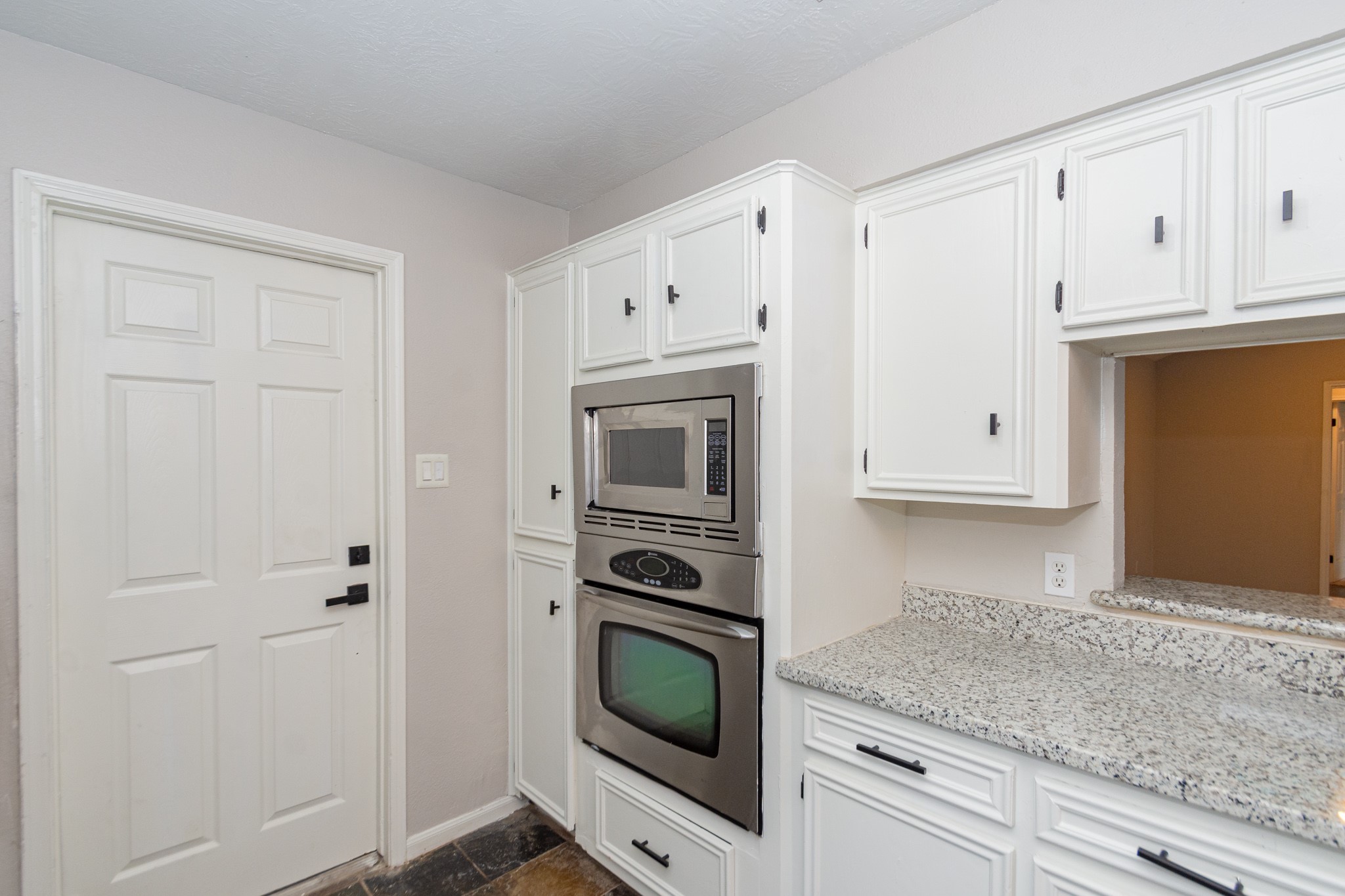 29019 Stapleford Street Spring, TX 77386 - Photo 13 of 29 a kitchen with granite countertop white cabinets and refrigerator