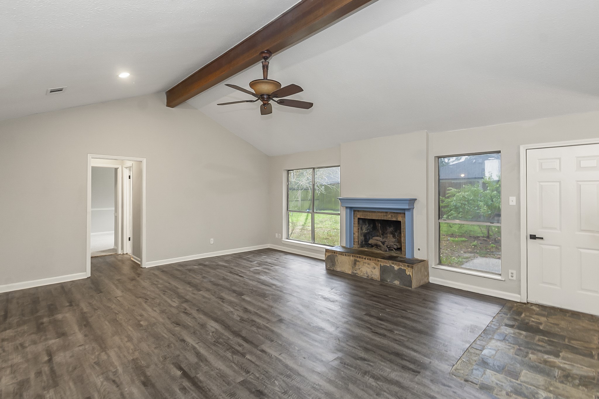 29019 Stapleford Street Spring, TX 77386 - Photo 4 of 29 a view of an empty room with wooden floor fireplace and a window