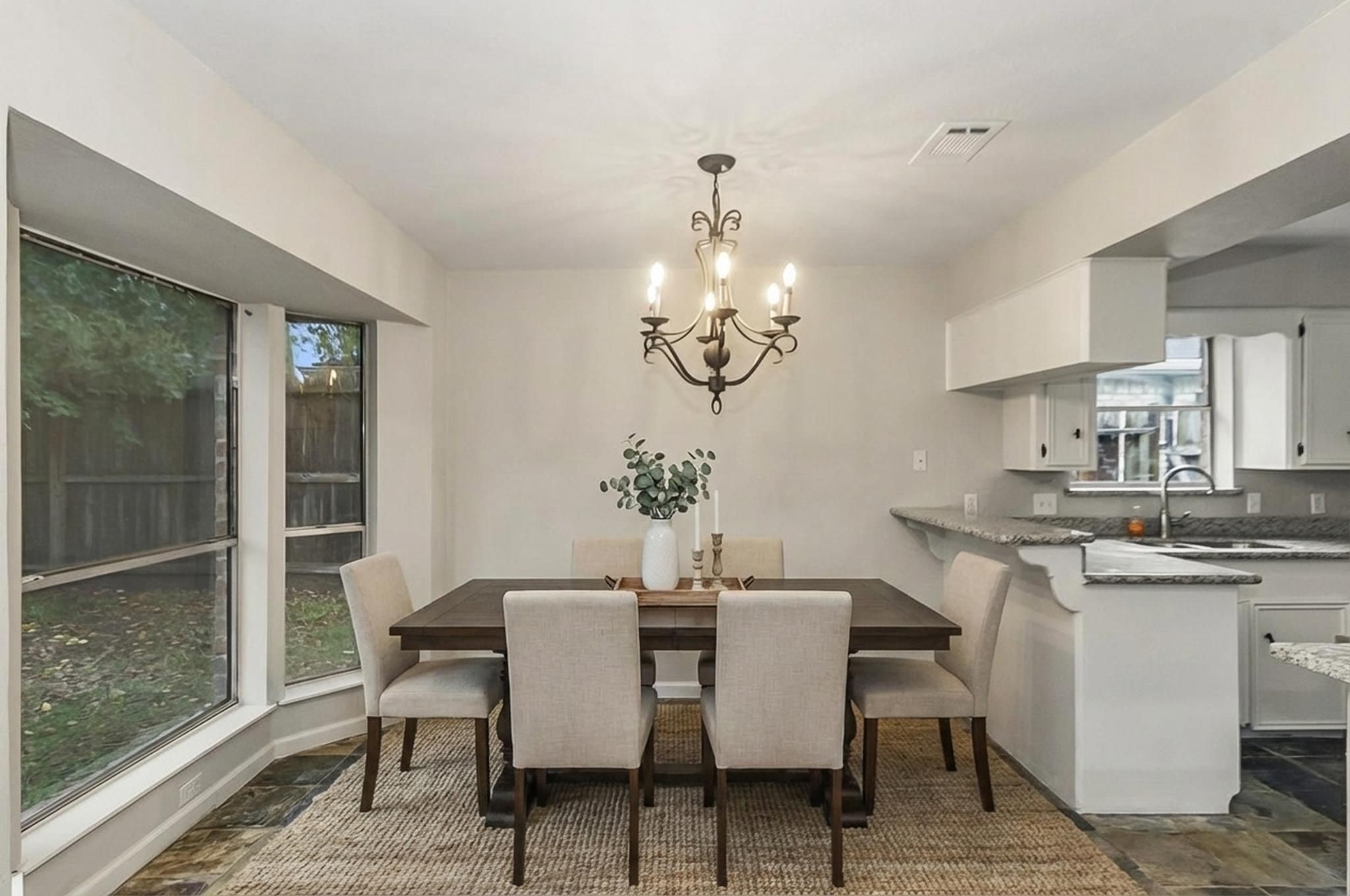 29019 Stapleford Street Spring, TX 77386 - Photo 6 of 29 a dining room with wooden floor a chandelier a wooden table and chairs