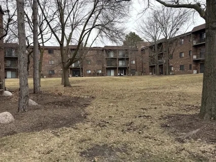 a big house with trees in front of it