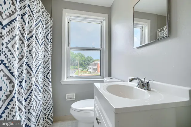 a white sink sitting next to a white toilet