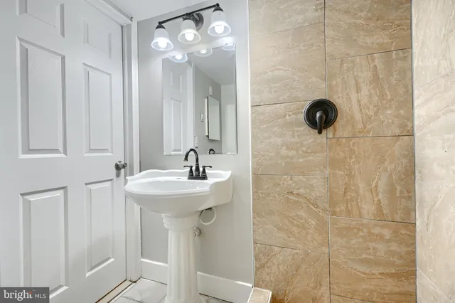 a bathroom with a sink a shower and a mirror