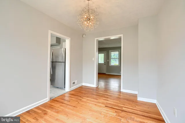 a view of a room with wooden floor and bathroom