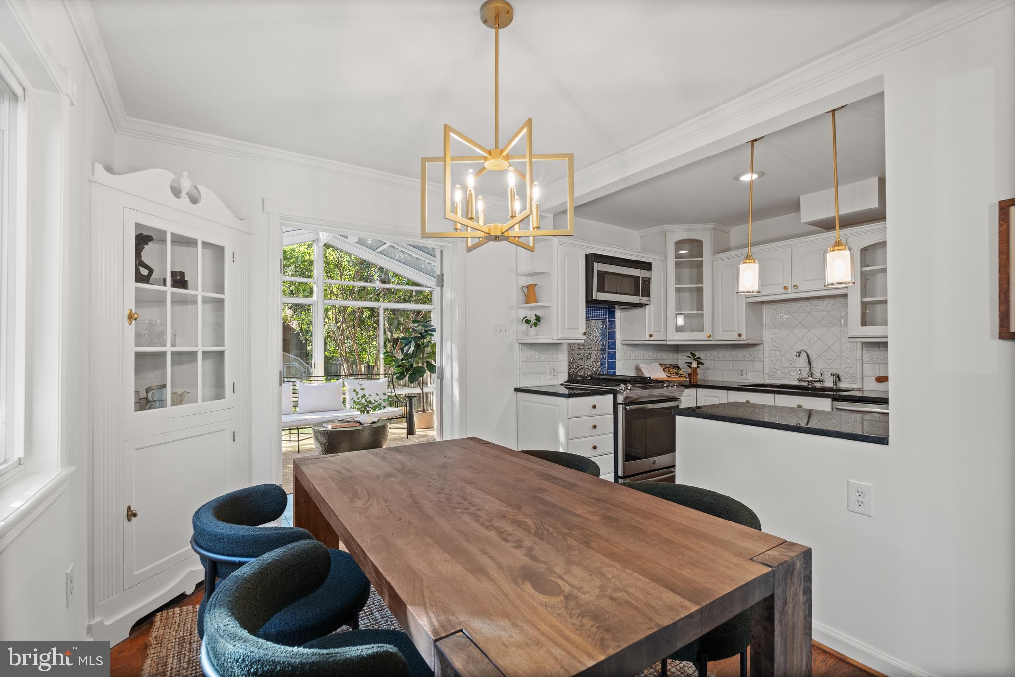 307 East Oxford Avenue, Unit 1/2 Alexandria, VA 22301 - Photo 12 of 34 a kitchen with stainless steel appliances granite countertop a stove refrigerator a sink dishwasher a dining table and chairs with wooden floor