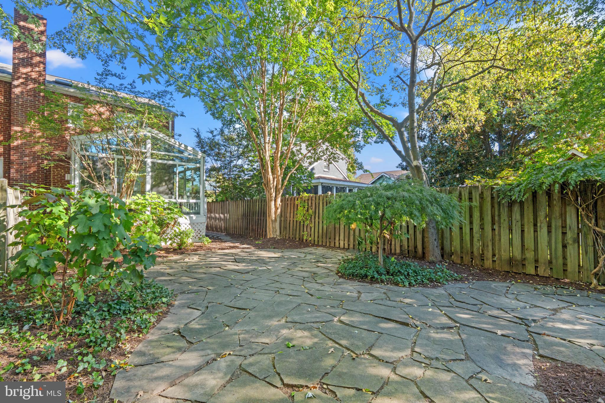 307 East Oxford Avenue, Unit 1/2 Alexandria, VA 22301 - Photo 30 of 34 a view of a backyard with plants and large trees