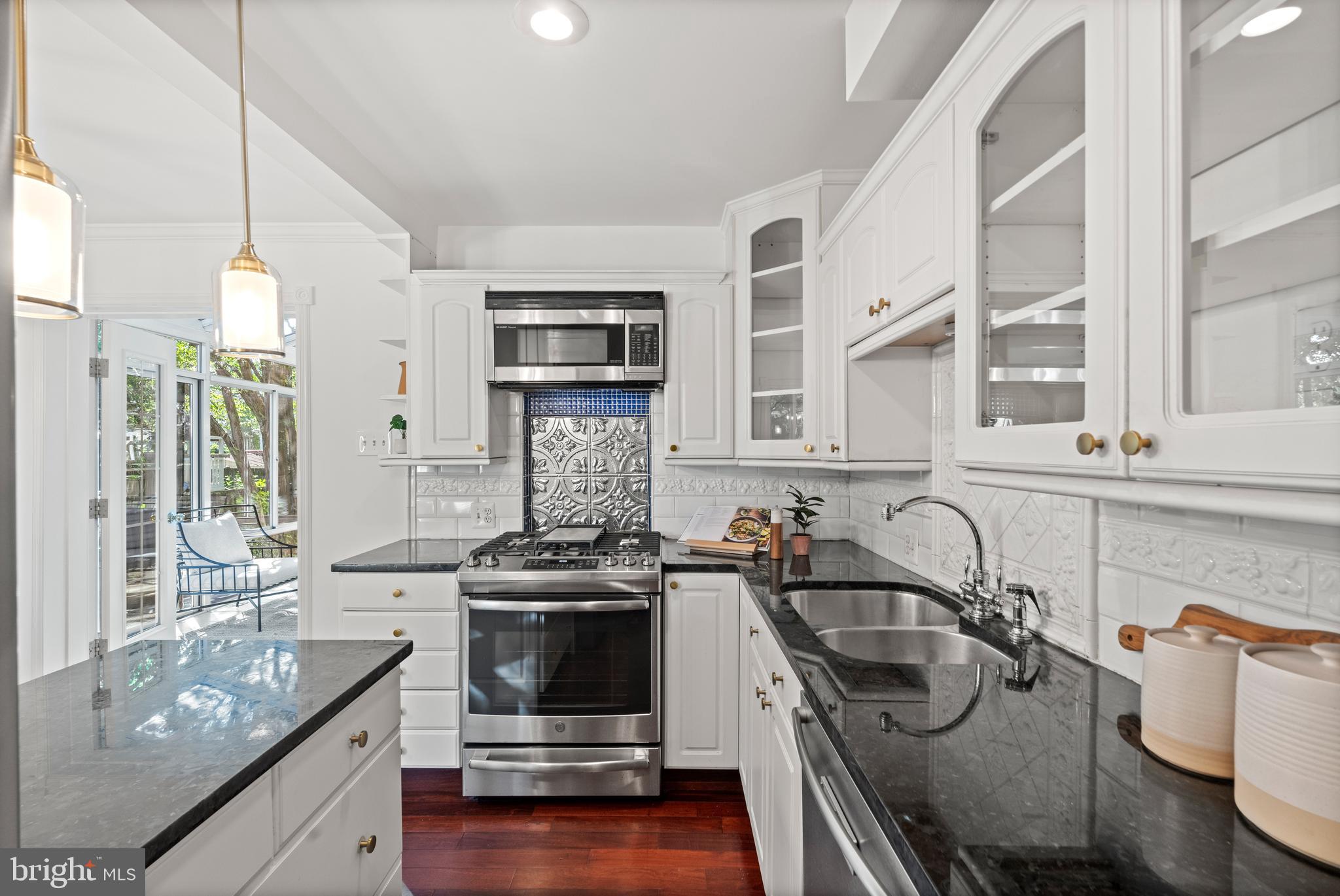 307 East Oxford Avenue, Unit 1/2 Alexandria, VA 22301 - Photo 5 of 34 a kitchen with a stove a sink and a microwave