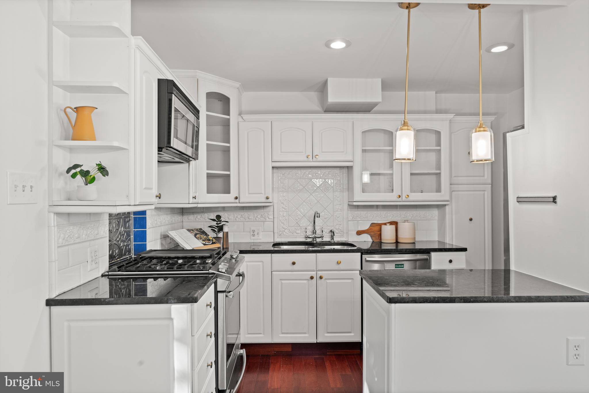 307 East Oxford Avenue, Unit 1/2 Alexandria, VA 22301 - Photo 6 of 34 a kitchen with stainless steel appliances granite countertop a sink a stove and a refrigerator