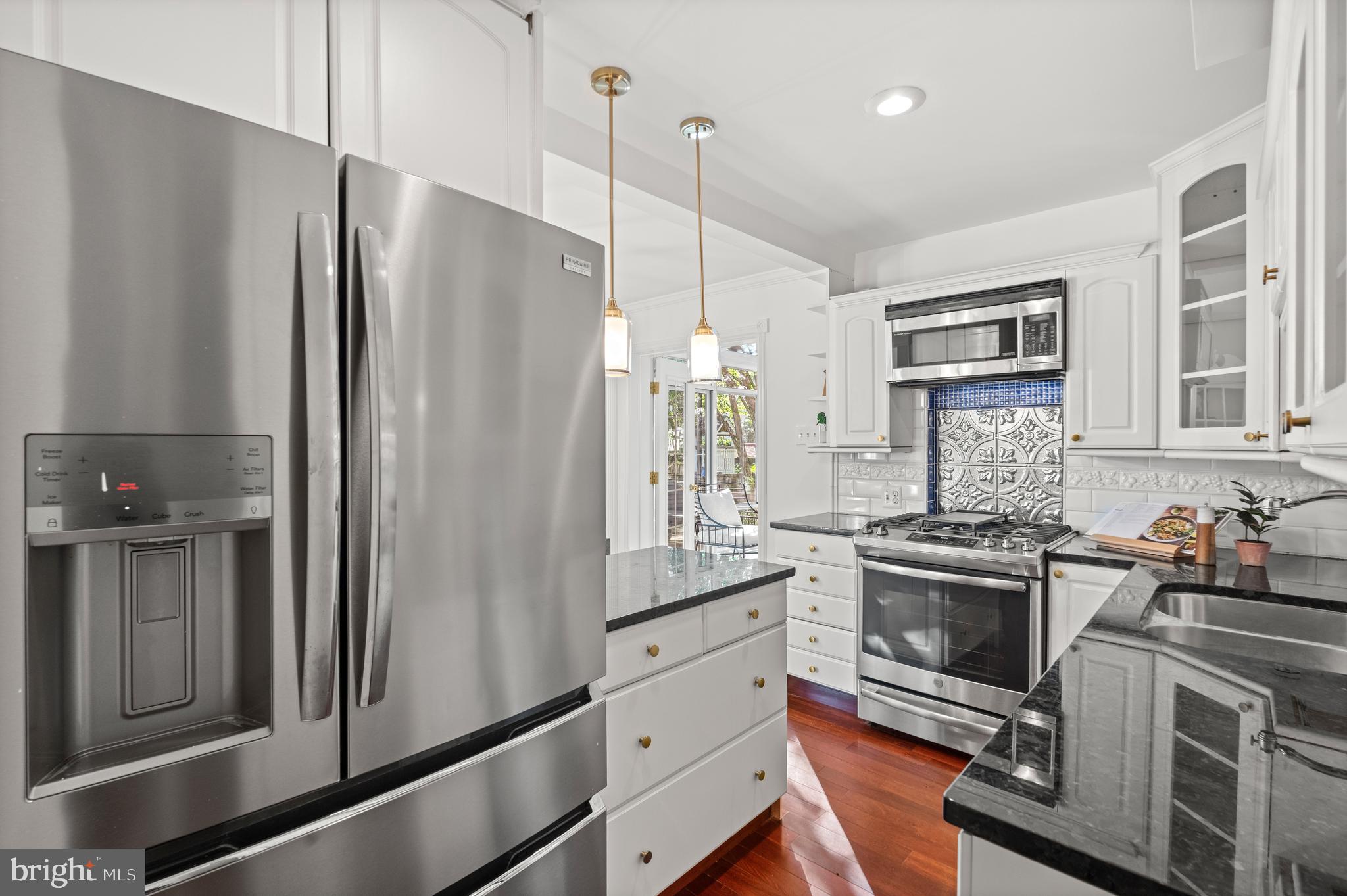 307 East Oxford Avenue, Unit 1/2 Alexandria, VA 22301 - Photo 7 of 34 a kitchen with stainless steel appliances a refrigerator sink and stove